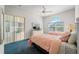 Bright bedroom featuring dual beds, large window, and outdoor patio access at 1130 Hominy Hill Dr, Trinity, FL 34655