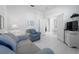 Cozy bedroom with striped sofa and a view into an adjacent room at 1130 Hominy Hill Dr, Trinity, FL 34655