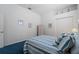 Cozy bedroom showcasing blue carpeting, tasteful decor, and ample closet space at 1130 Hominy Hill Dr, Trinity, FL 34655
