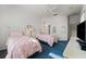 Bedroom with two twin beds, a ceiling fan and neutral colored walls at 1130 Hominy Hill Dr, Trinity, FL 34655