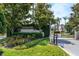 Beautiful entrance to the Peachtree community with iron gate, professional landscaping, and privacy at 1130 Hominy Hill Dr, Trinity, FL 34655