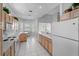 Well-lit kitchen with white appliances, plenty of counter space, and an adjacent breakfast nook at 1130 Hominy Hill Dr, Trinity, FL 34655