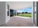 Screened lanai featuring views of the golf course and lush landscaping beyond at 1130 Hominy Hill Dr, Trinity, FL 34655