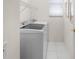 Laundry room with tile flooring, a new washer and dryer and storage shelves at 1130 Hominy Hill Dr, Trinity, FL 34655