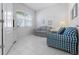 Cozy living area with tile flooring, a sitting area and natural light from the large window at 1130 Hominy Hill Dr, Trinity, FL 34655