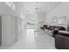 Open-concept living room with tile floors, a tray ceiling, and large sliding doors to the backyard at 1130 Hominy Hill Dr, Trinity, FL 34655