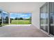 Serene screened lanai with a view of lush greenery and the golf course, perfect for relaxation at 1130 Hominy Hill Dr, Trinity, FL 34655