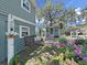 Charming backyard featuring a porch swing, garden, and cozy shed, perfect for outdoor relaxation and storage at 11337 Knights Griffin Rd, Thonotosassa, FL 33592