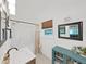 Cozy bathroom features a bathtub, vanity with a sink, and a window for natural light at 11337 Knights Griffin Rd, Thonotosassa, FL 33592