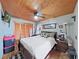 Charming bedroom with wood-paneled ceiling, wardrobe, and modern décor at 11337 Knights Griffin Rd, Thonotosassa, FL 33592