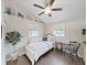 Cozy bedroom with natural light, neutral colors, simple decor, and hardwood floors at 11337 Knights Griffin Rd, Thonotosassa, FL 33592