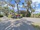 Carport with a boat, providing convenient storage and protection from the elements at 11337 Knights Griffin Rd, Thonotosassa, FL 33592