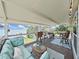 Inviting covered deck with cozy seating, grill, and lake views at 11337 Knights Griffin Rd, Thonotosassa, FL 33592