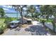 Charming lakefront property featuring a well-maintained yard, carport, and additional storage at 11337 Knights Griffin Rd, Thonotosassa, FL 33592