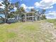 Two-story home with balconies overlooking a sprawling lawn and picturesque lake views at 11337 Knights Griffin Rd, Thonotosassa, FL 33592