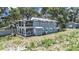 Two-story home with multiple balconies and views from every level, surrounded by lush greenery at 11337 Knights Griffin Rd, Thonotosassa, FL 33592