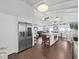 Bright kitchen with stainless steel refrigerator and a spacious center island at 11337 Knights Griffin Rd, Thonotosassa, FL 33592