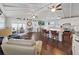 Open-concept living area featuring an eat-in kitchen island, vaulted ceilings, ceiling fans, and modern finishes at 11337 Knights Griffin Rd, Thonotosassa, FL 33592