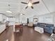 Open-concept living room featuring hardwood floors and natural lighting at 11337 Knights Griffin Rd, Thonotosassa, FL 33592