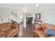 Open-concept living area with hardwood floors, neutral colors, and a view of the laundry room at 11337 Knights Griffin Rd, Thonotosassa, FL 33592