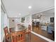 Open-concept living and dining area with dark wood floors and lots of natural light at 11337 Knights Griffin Rd, Thonotosassa, FL 33592