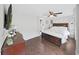Cozy main bedroom features a ceiling fan, wood flooring, and a connecting door to another room at 11337 Knights Griffin Rd, Thonotosassa, FL 33592