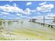 Scenic view of the serene lake featuring docks and clear blue sky at 11337 Knights Griffin Rd, Thonotosassa, FL 33592