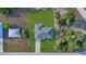 Aerial top-down view of a home with pristine landscaping, a driveway, and a well-manicured lawn at 11369 Gulfstream Blvd, Port Charlotte, FL 33981