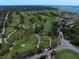 Expansive aerial view of the golf course with lush green fairways and water features at 12 Country Club Ln, Belleair, FL 33756