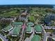 Aerial view of townhouses with green roofs and tropical landscaping in a golf course community at 12 Country Club Ln, Belleair, FL 33756