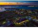 Picturesque aerial view of the coastline, golf course and city skyline at dusk at 12 Country Club Ln, Belleair, FL 33756
