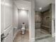 Bathroom featuring toilet room and frameless glass shower with seat at 12 Country Club Ln, Belleair, FL 33756