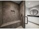 Modern bathroom with a frameless glass shower and neutral tile at 12 Country Club Ln, Belleair, FL 33756