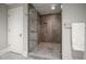 Modern bathroom with frameless glass shower and stone tile at 12 Country Club Ln, Belleair, FL 33756