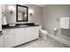 Bathroom with a vanity, granite countertop, and a toilet at 12 Country Club Ln, Belleair, FL 33756