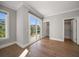Bedroom featuring hardwood floors and doors to the private patio at 12 Country Club Ln, Belleair, FL 33756