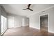 Bright bedroom with hardwood floors, neutral walls, and convenient access to the bathroom at 12 Country Club Ln, Belleair, FL 33756