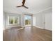 Bright bedroom with ceiling fan and sliding doors to the balcony at 12 Country Club Ln, Belleair, FL 33756