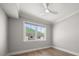 Bright bedroom featuring hardwood floors and a large window offering ample natural light at 12 Country Club Ln, Belleair, FL 33756
