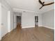 Spacious bedroom featuring hardwood floors and open doorway at 12 Country Club Ln, Belleair, FL 33756