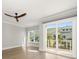 Bedroom featuring ceiling fan and sliding doors to private patio at 12 Country Club Ln, Belleair, FL 33756