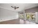 Bright bedroom with hardwood floors, fan, and large windows at 12 Country Club Ln, Belleair, FL 33756