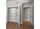 Bedroom walk-in closet with custom shelving and hardwood floors at 12 Country Club Ln, Belleair, FL 33756