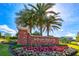 Attractive Bellevue Place & Inn sign with a lush flowerbed and mature palms at 12 Country Club Ln, Belleair, FL 33756