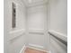 Modern elevator with white paneled walls and wood flooring at 12 Country Club Ln, Belleair, FL 33756