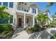 Two-story townhouse with a mix of traditional and modern architectural elements and tropical landscaping at 12 Country Club Ln, Belleair, FL 33756