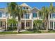 Two-story townhouse with a mix of traditional and modern architectural elements and tropical landscaping at 12 Country Club Ln, Belleair, FL 33756
