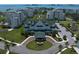 Grand white building with a green roof, surrounded by lush lawns and a circular driveway entrance at 12 Country Club Ln, Belleair, FL 33756