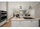 Open concept kitchen with island and modern appliances with an open view of living area at 12 Country Club Ln, Belleair, FL 33756