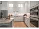 Modern kitchen with stainless steel appliances, ample storage, and sleek countertops at 12 Country Club Ln, Belleair, FL 33756